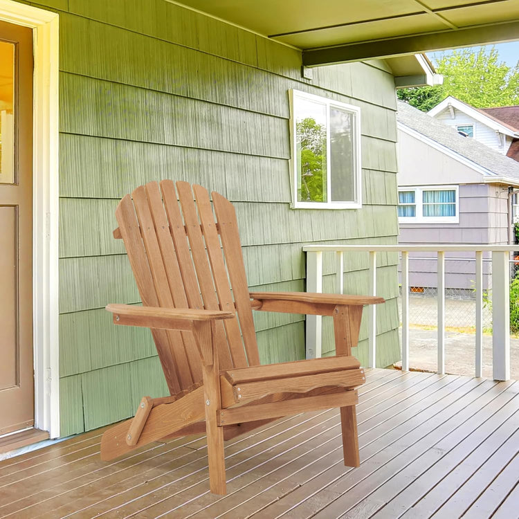 Wooden Adirondack chair on a deck with a green house and white door in the background.