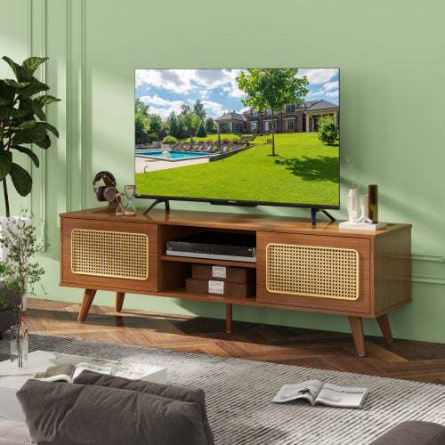 Wooden TV stand with a television displaying an outdoor scene, placed against a green wall in a living room.