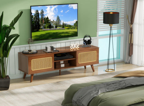 Wooden TV stand with a television displaying an outdoor scene, surrounded by decor items in a room.