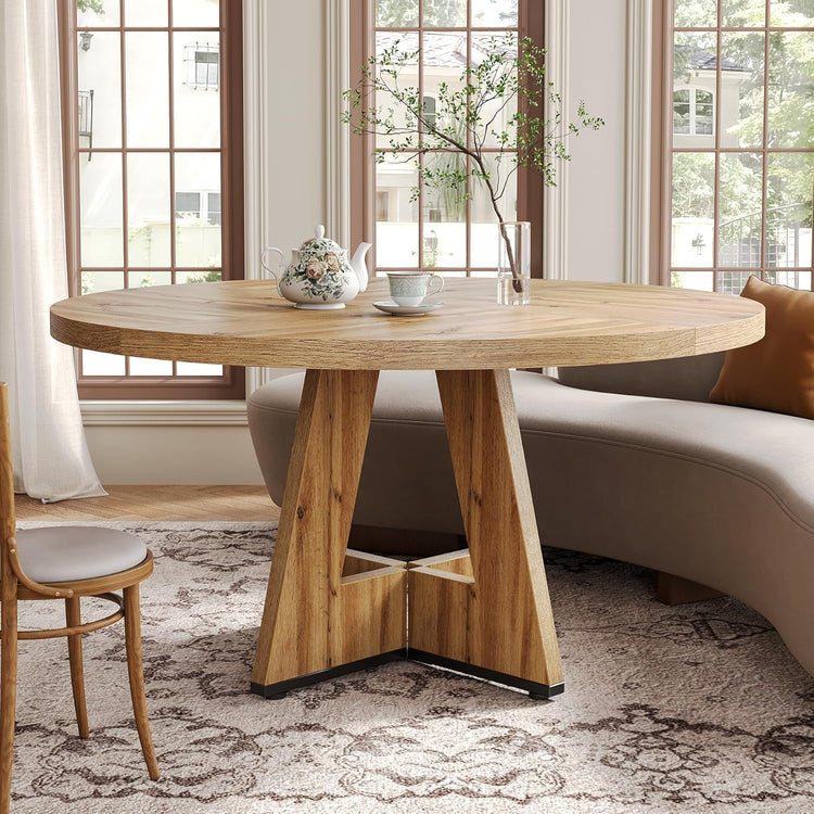Wooden dining table with decorative items in a living room setting