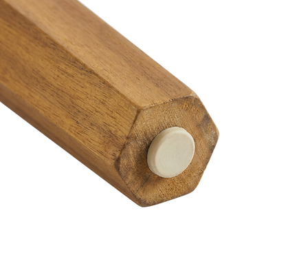 Foot cap detail on the acacia wood table leg, protecting the wood from ground contact