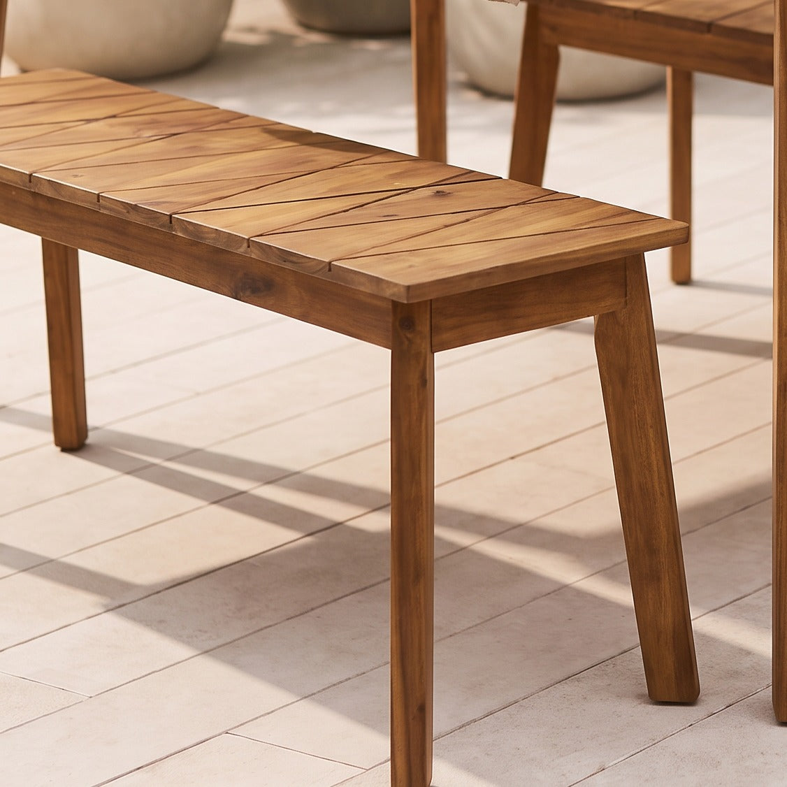 Environmental close-up of the acacia wood bench seating in an outdoor patio setting
