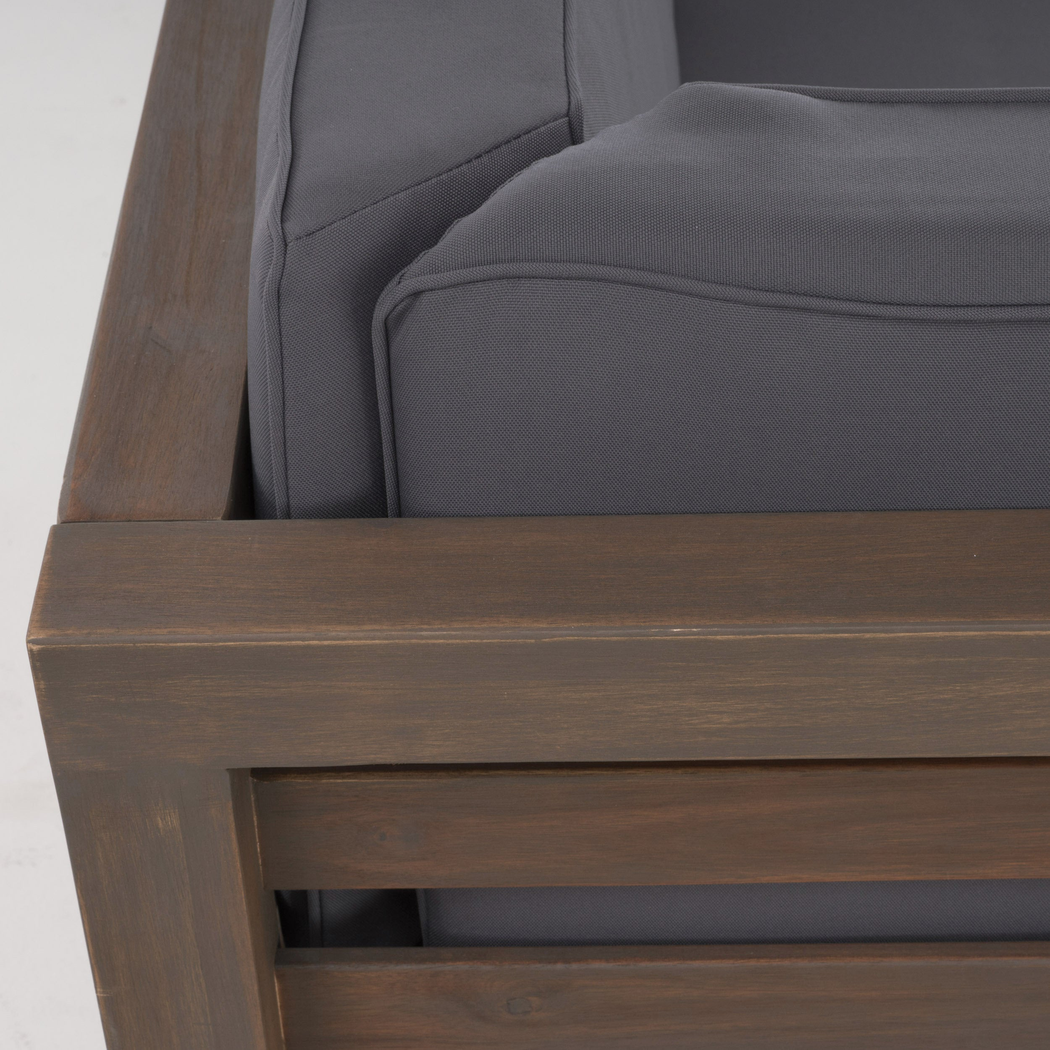 Acacia arm post and slatted side panel meeting the seat frame, close-up detail