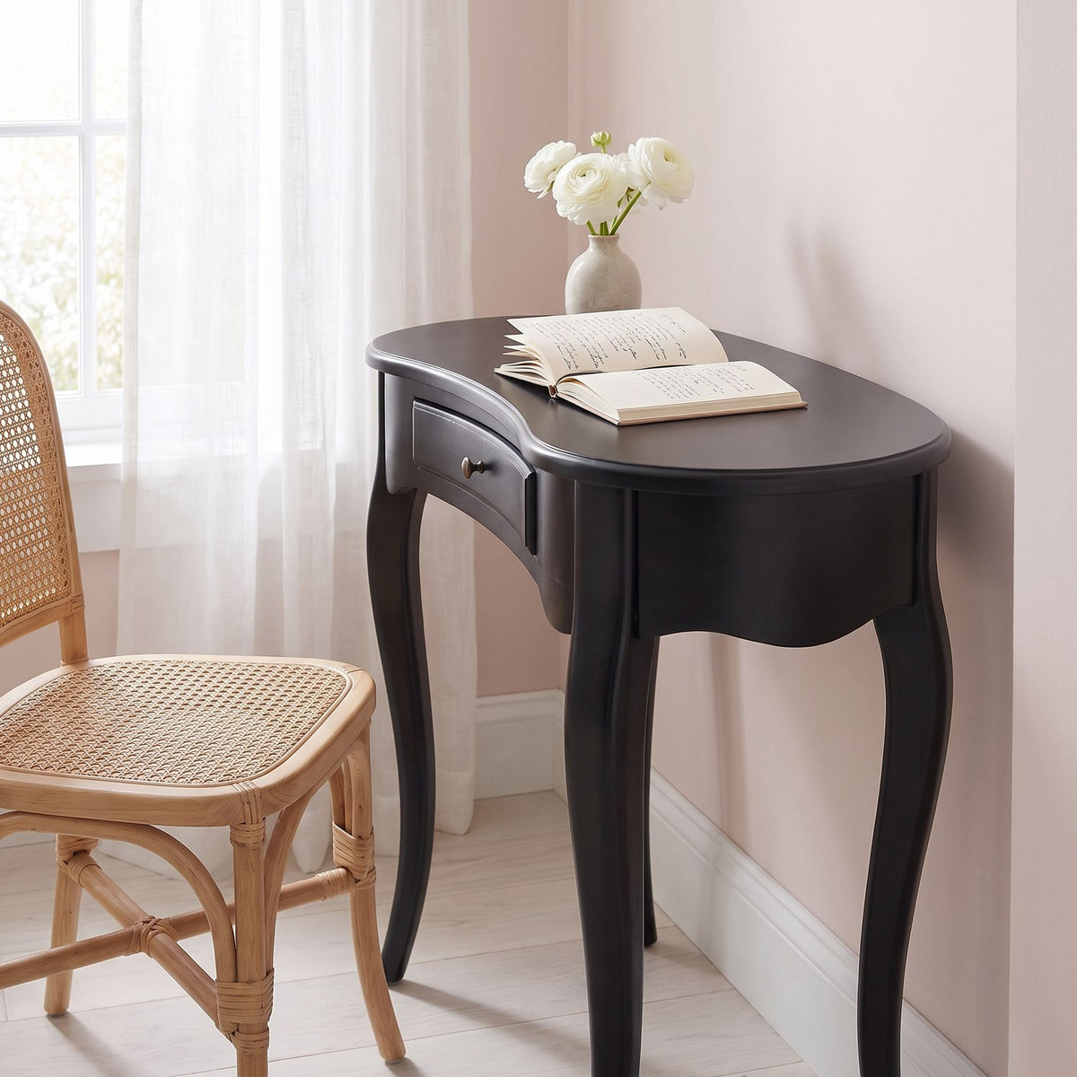 Closer view of the black desk in the same reading nook from the right