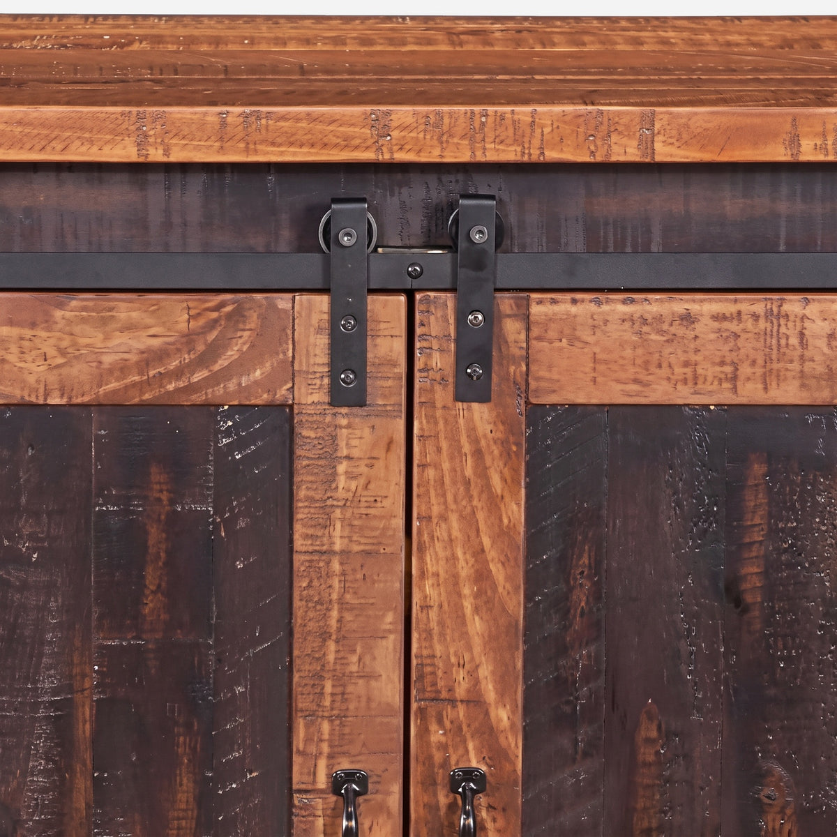 Black metal track and roller hangers where the two pine barn doors meet (close-up detail)