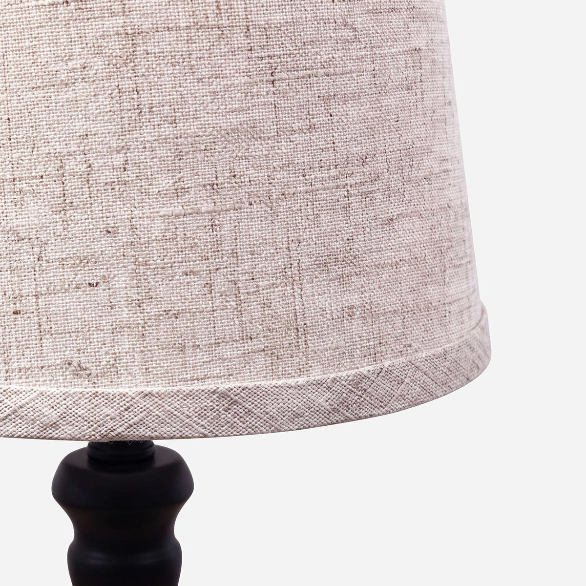 Close-up of the natural linen weave and bound lower rim of the shade (close-up detail)