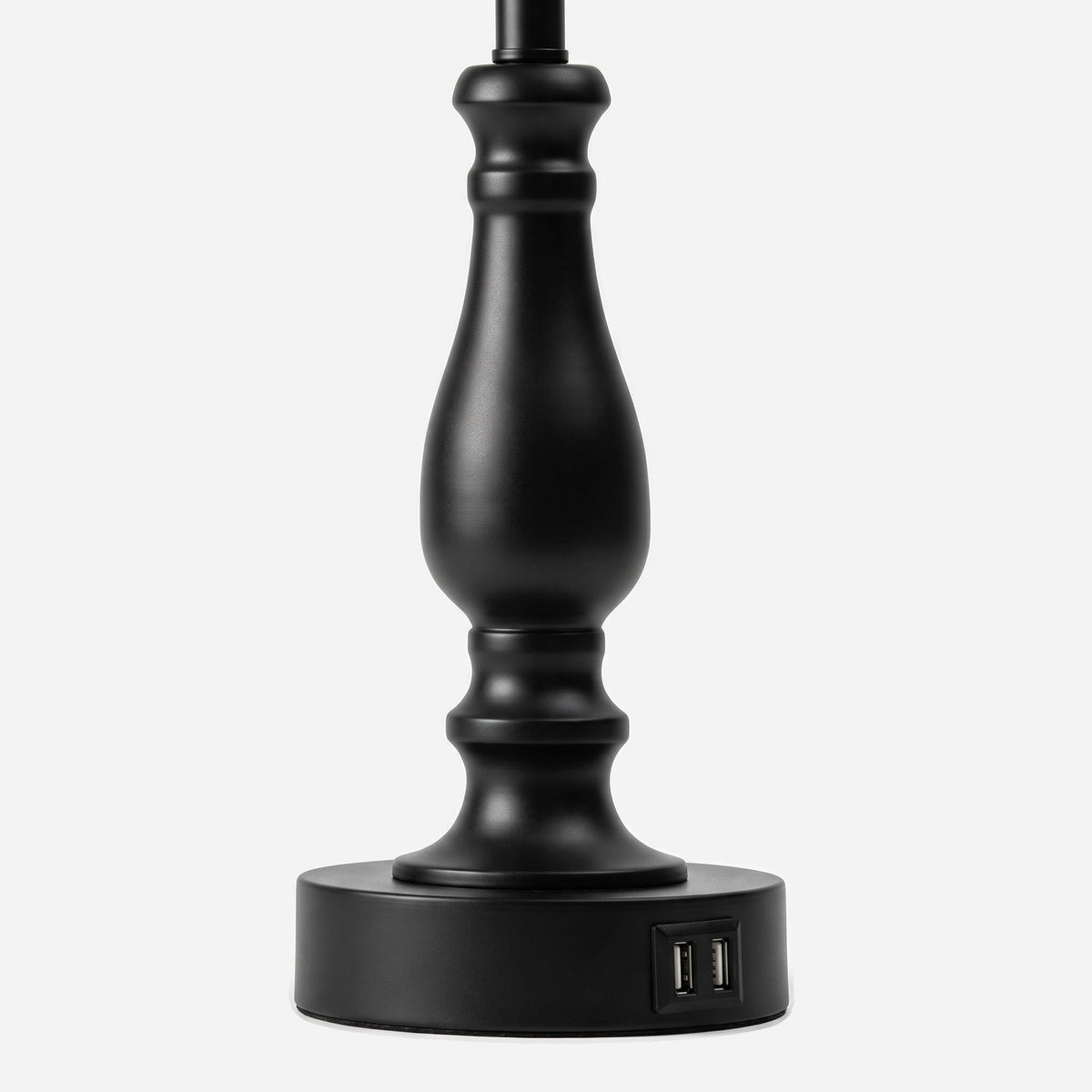 Close-up of the turned black metal column stepping into the round base (close-up detail)