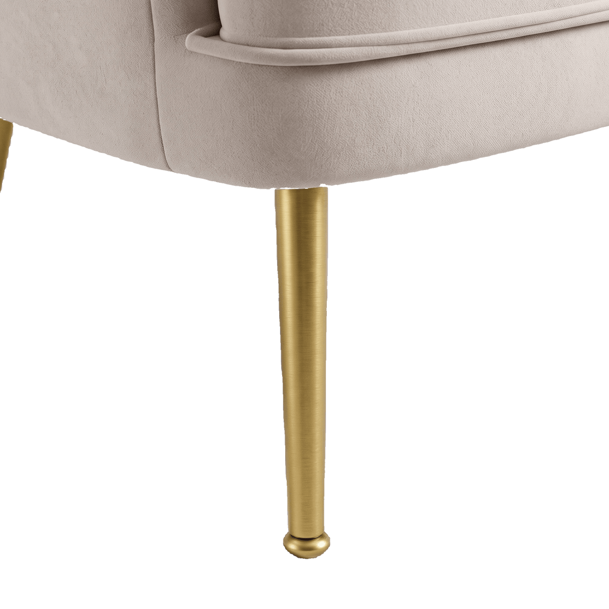 Tapered gold metal leg of the beige velvet accent chair (close-up detail)