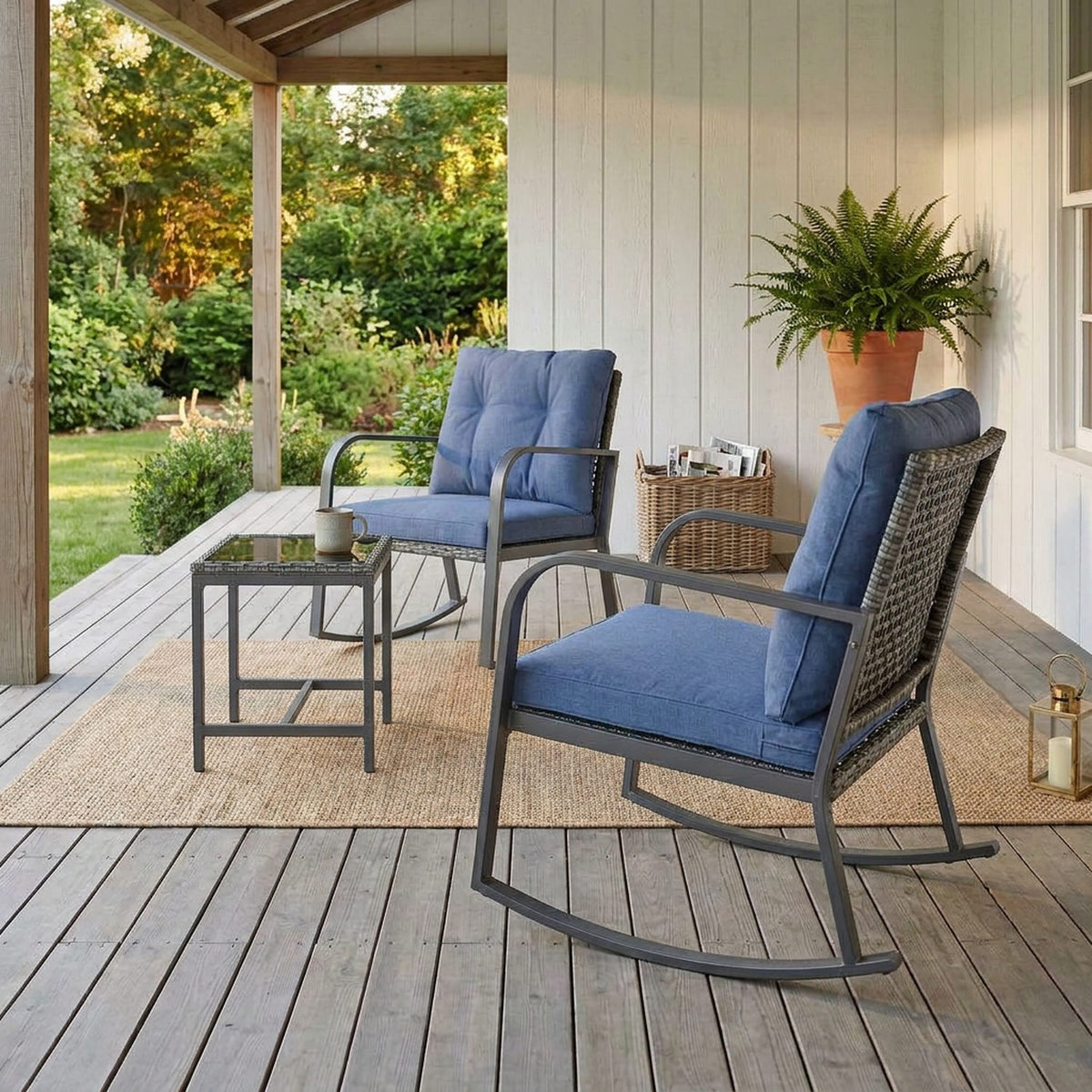 Three-quarter view of a rocking chair and glass-top side table on a veranda deck beside a fern and wicker basket