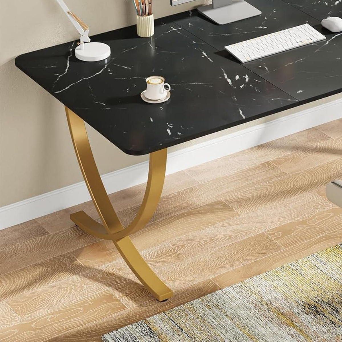 Close-up of the crossed gold steel arc leg and adjustable foot pad