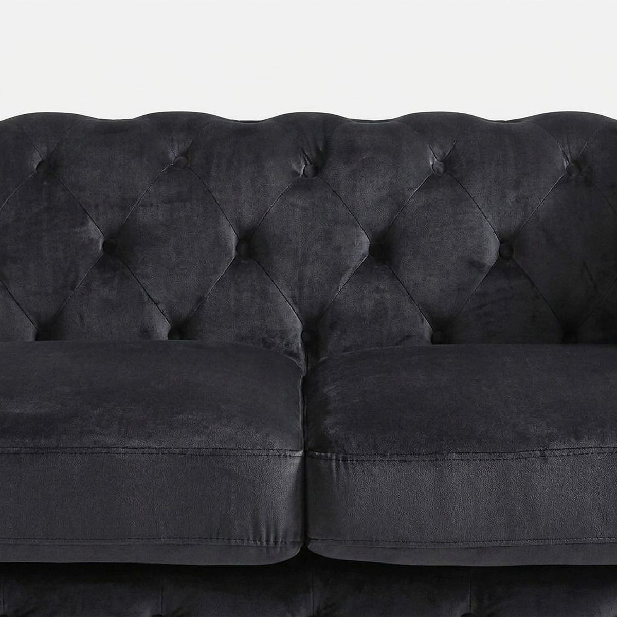 Diamond button tufting on the velvet back above the two seat cushions (close-up detail)