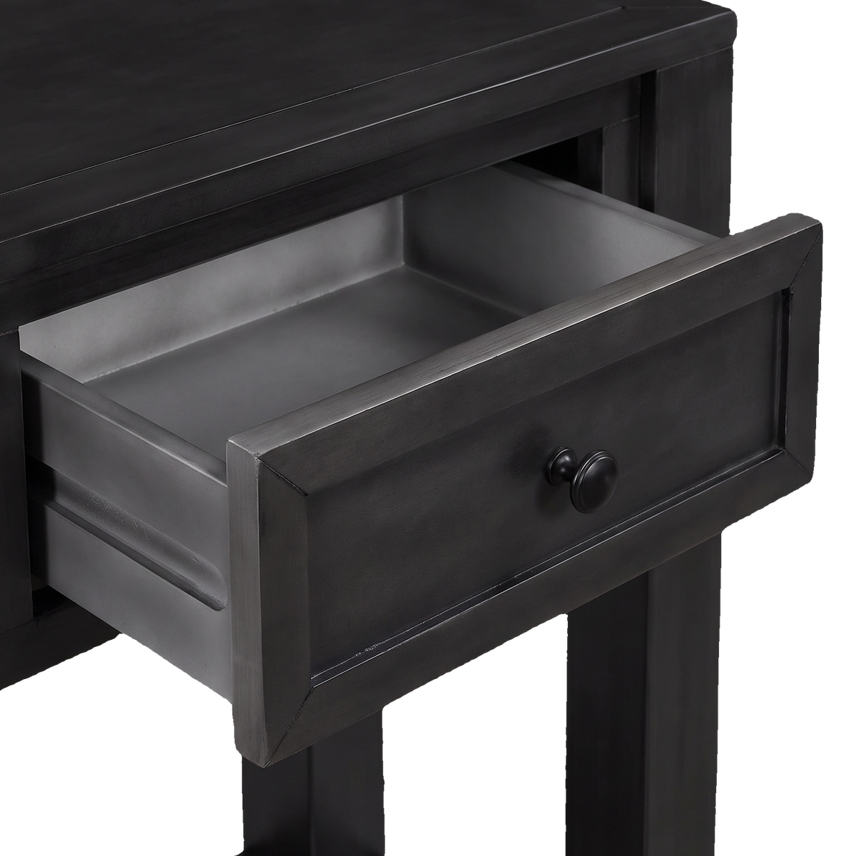 Close-up of one drawer pulled half open, showing its grey drawer box and round black knob (close-up detail)
