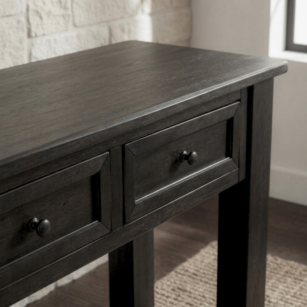 The grained top and two drawers by a whitewashed brick wall and window