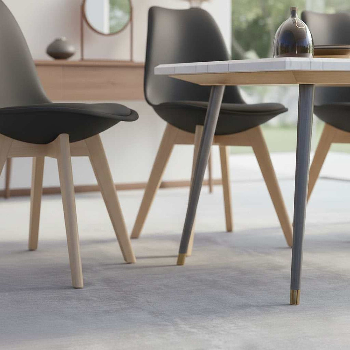Mid-century modern black plastic shell dining chairs with wooden legs, four-piece set around a dining table in a dining room