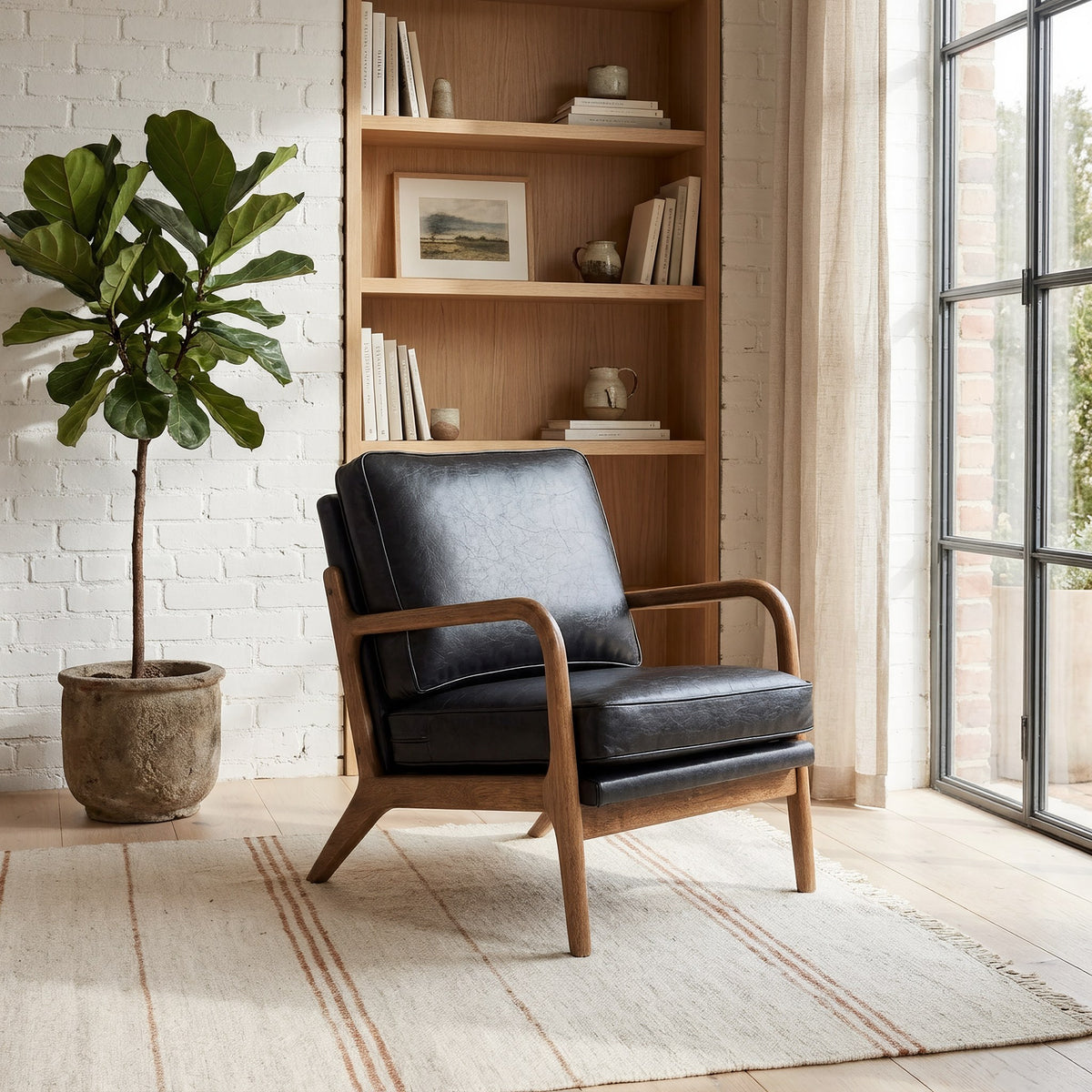 Black faux leather wood frame accent chair in a sunlit loft reading corner