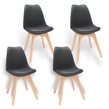 Four mid-century modern black plastic shell dining chairs with natural wood legs.