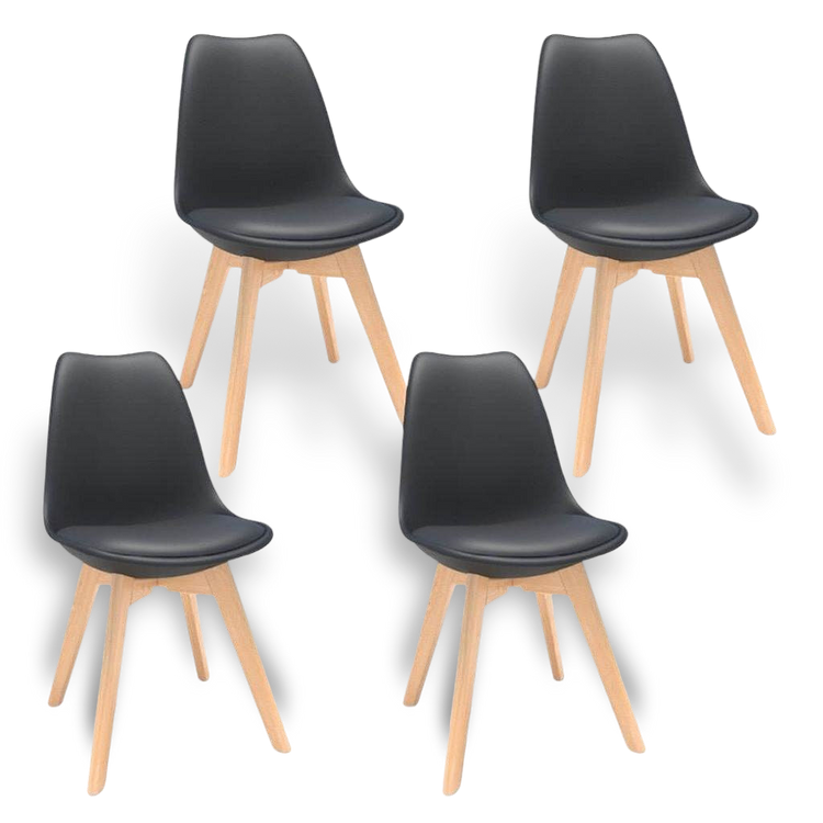 Four mid-century modern black plastic shell dining chairs with natural wood legs.