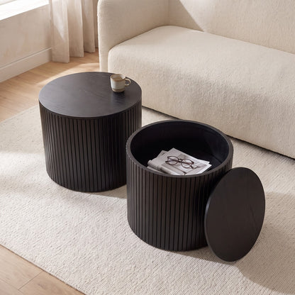 Black round nesting tables in a living room with the smaller top lifted off (room)