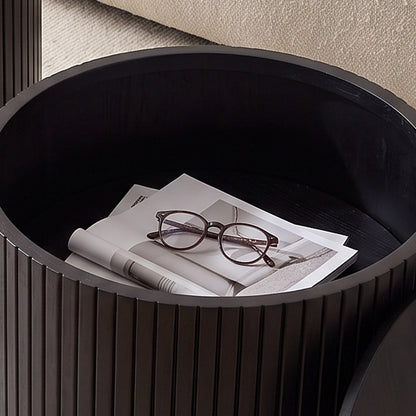 Open storage cavity inside the nesting table holding magazines and reading glasses (close-up detail)