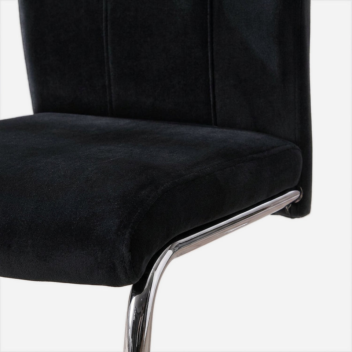 Foam-padded velvet seat meeting the chrome rail (close-up detail)