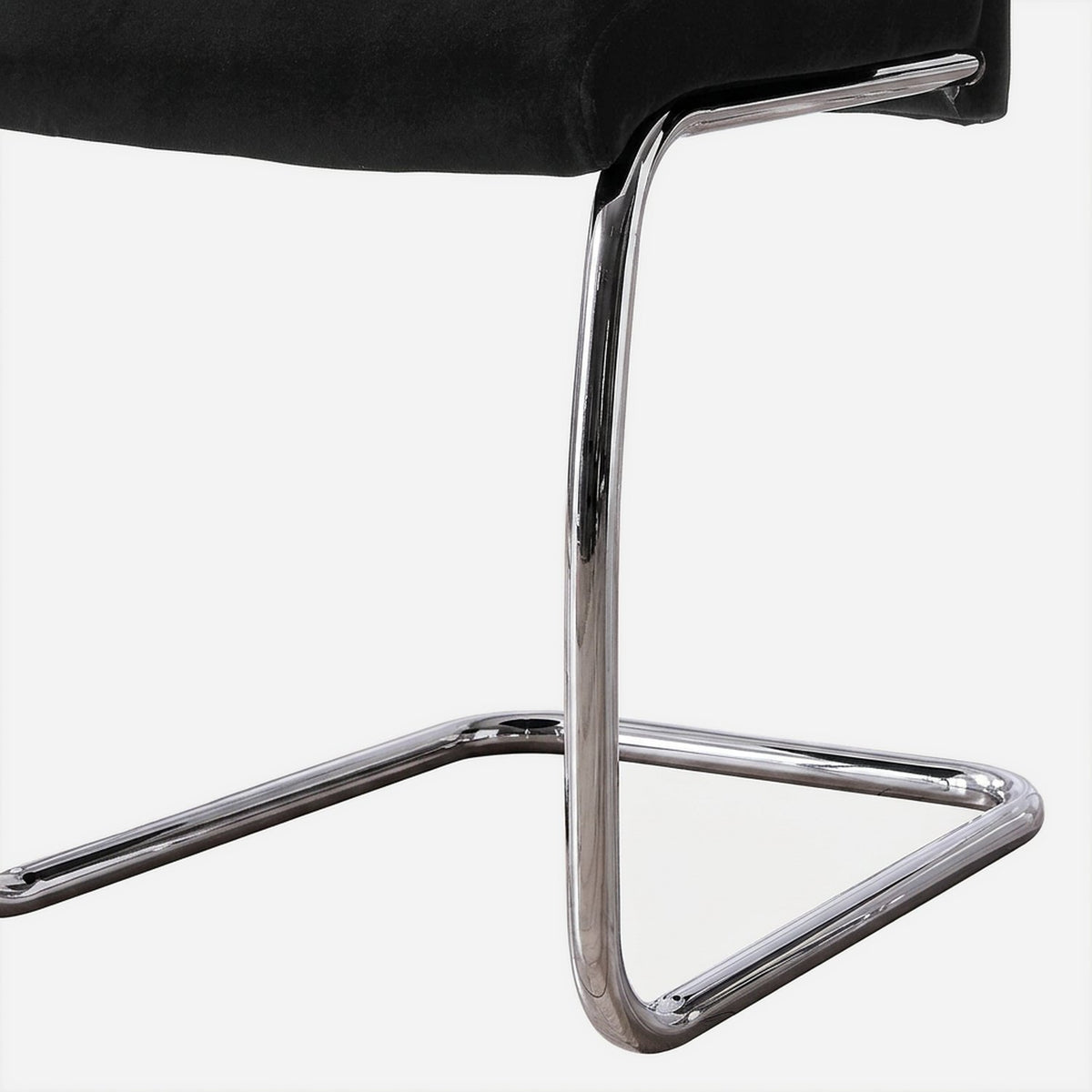 Mirror-chrome tube bend of a cantilever chair base (close-up detail)