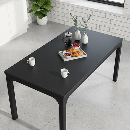 78-inch black rectangle dining table for 6-8 in a modern kitchen, with a French press coffee, croissants, and berries.