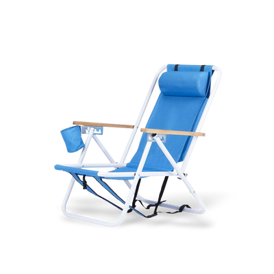 Premium blue portable beach chair with natural wooden armrests, a white rust-resistant frame, and an adjustable headrest pillow for neck support.
