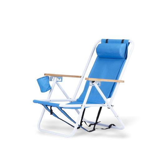 Premium blue portable beach chair with natural wooden armrests, a white rust-resistant frame, and an adjustable headrest pillow for neck support.