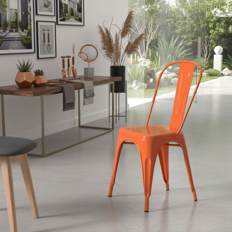 Vibrant rust metal dining chair with stackable design in a modern kitchen-dining space