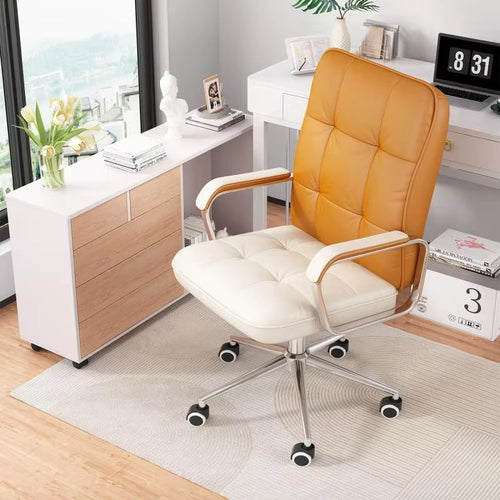 Leather swivel ergonomic desk chair with tufted orange-brown back and cream seat in a modern home office.