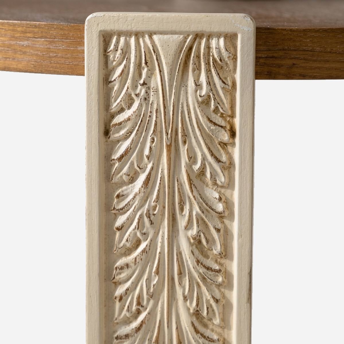 Close-up of the carved acanthus leaf panel on a cream arched coffee table leg