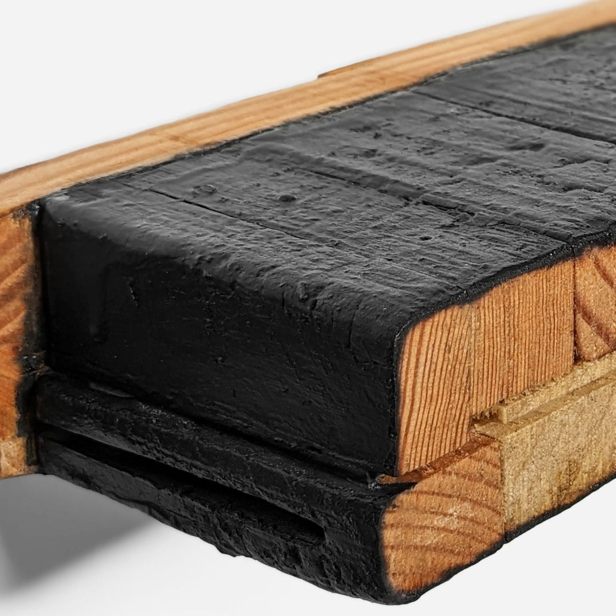 Close-up of charred black blocks and oiled end grain