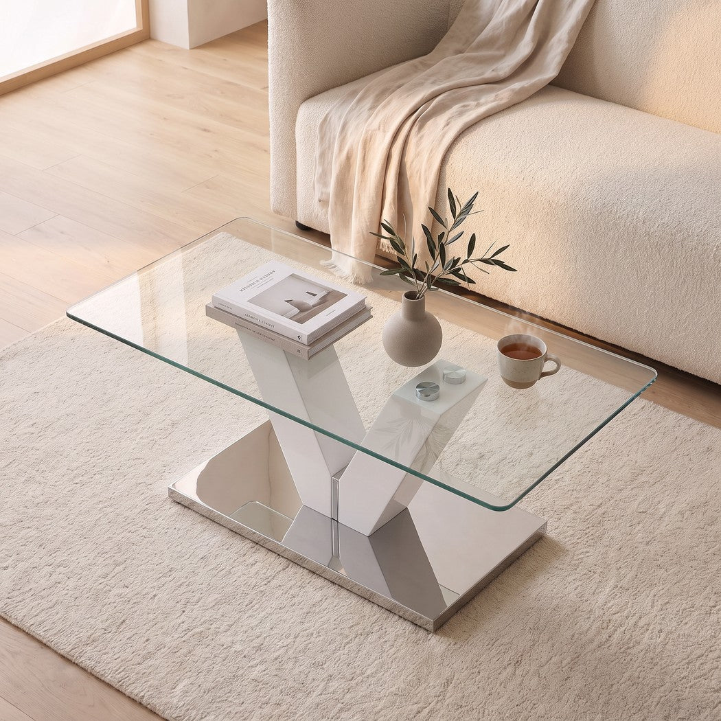Living room view from above of the V shaped coffee table with books, a vase and tea on the glass