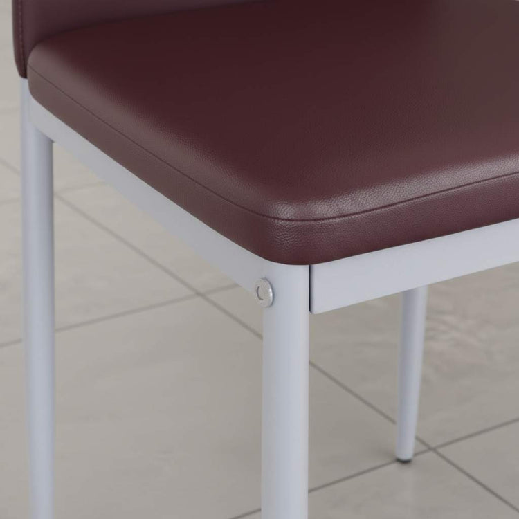 Modern high-back brown PVC dining chair with white metal legs, close-up of seat edge.