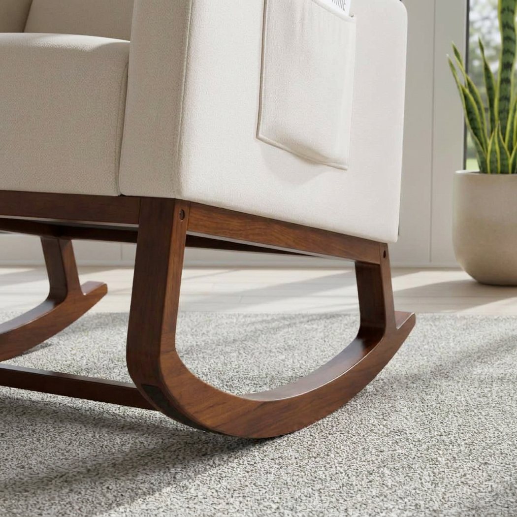 Curved walnut rocker base and fabric side pocket of the rocking chair on a rug (close-up detail)