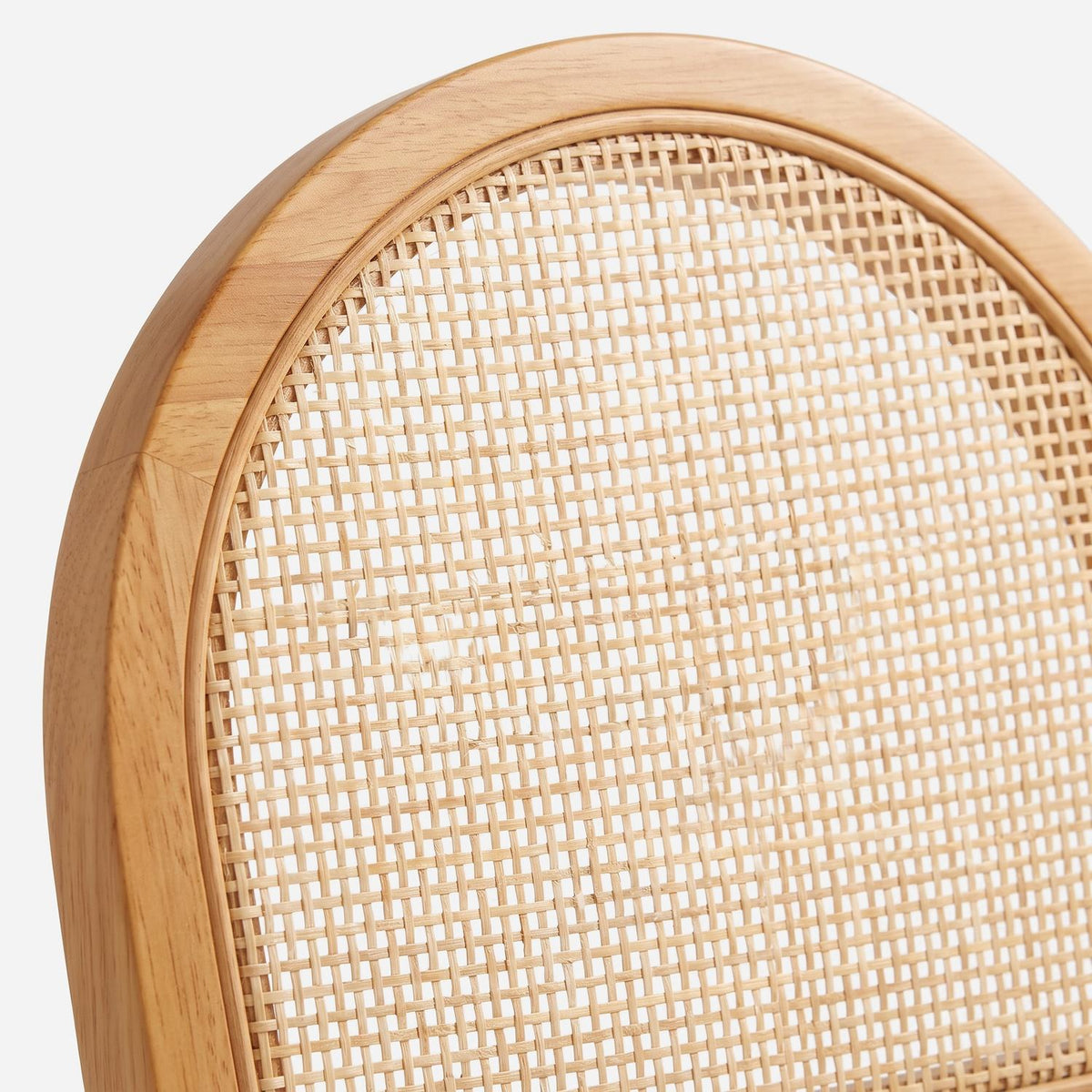 Close-up of the open woven cane panel set in the arched wood rim