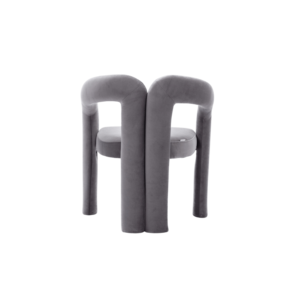 Velvet dining armchairs with plush gray upholstery and a curved back for a luxe, modern silhouette.