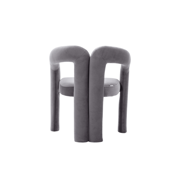 Velvet dining armchairs with plush gray upholstery and a curved back for a luxe, modern silhouette.