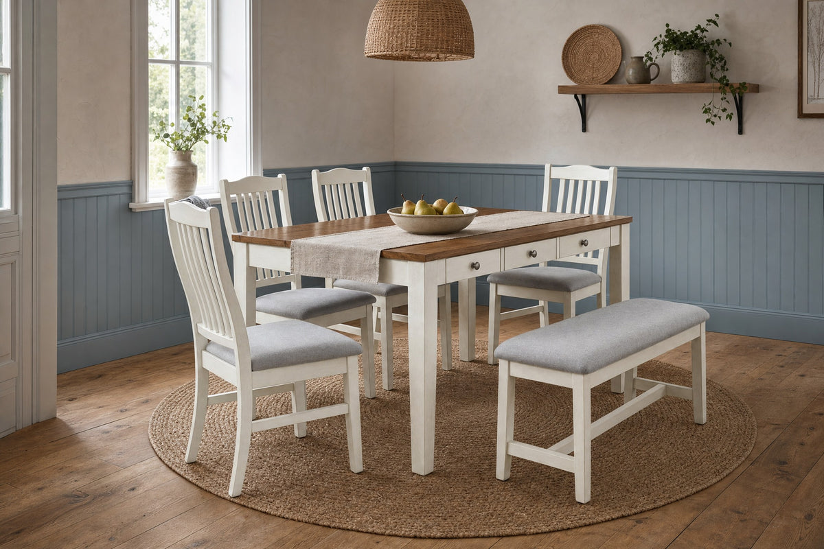 Walnut-top table, chairs and bench in a bright cottage dining room with blue-grey wainscoting