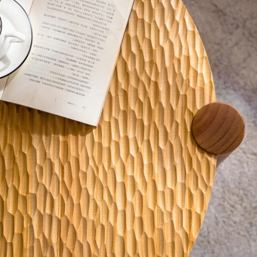 Round solid wood coffee table, carved tabletop with book and coffee cup