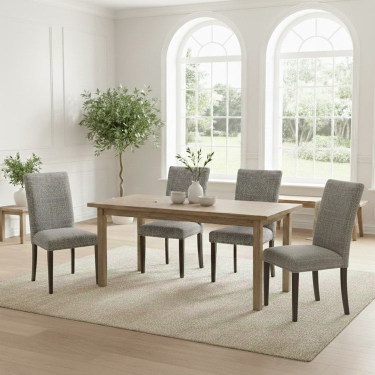 Dining room with wooden table and gray chairs in a bright room with large windows.