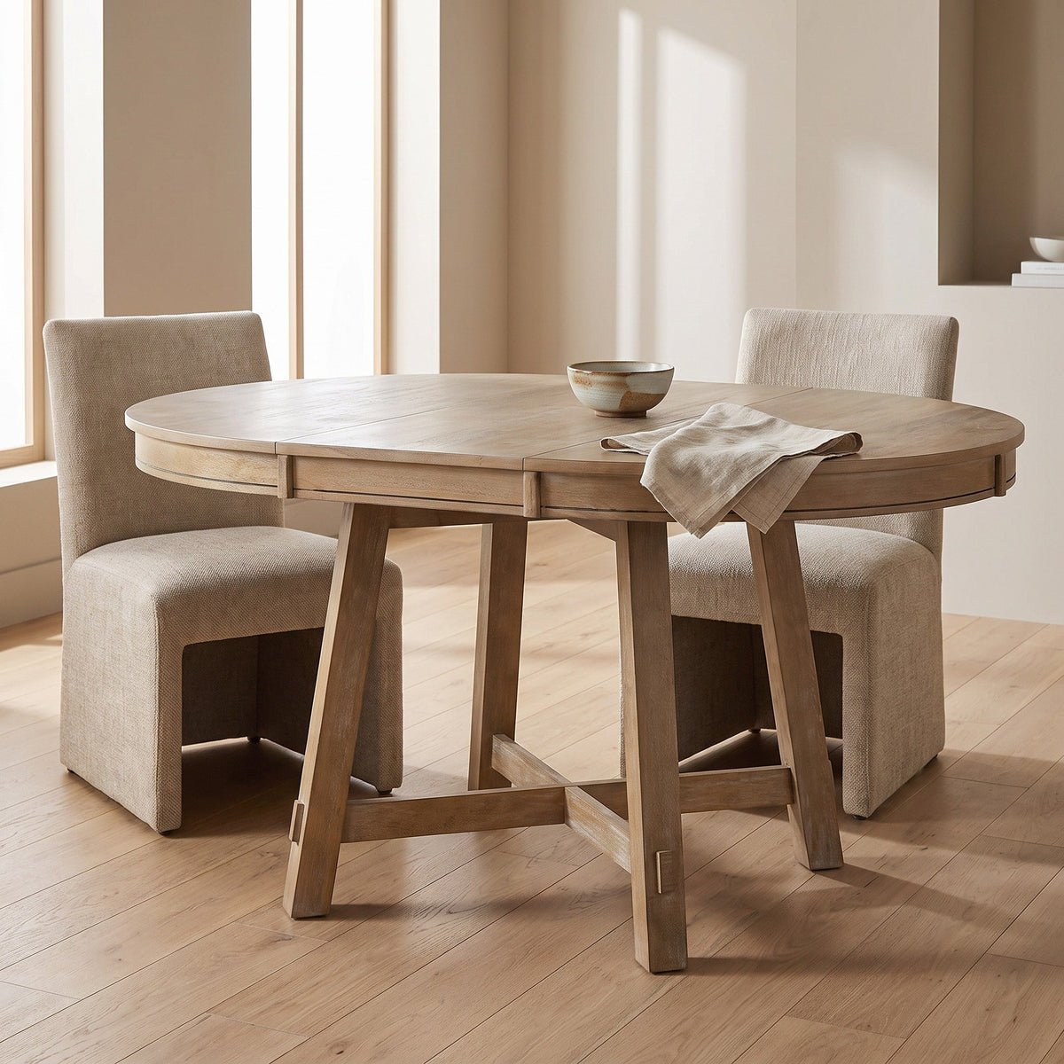 Round table opened to an oval in a bright dining room