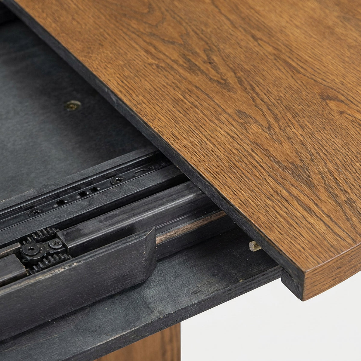 Close-up of the removable leaf rails and seam on the walnut extendable dining table