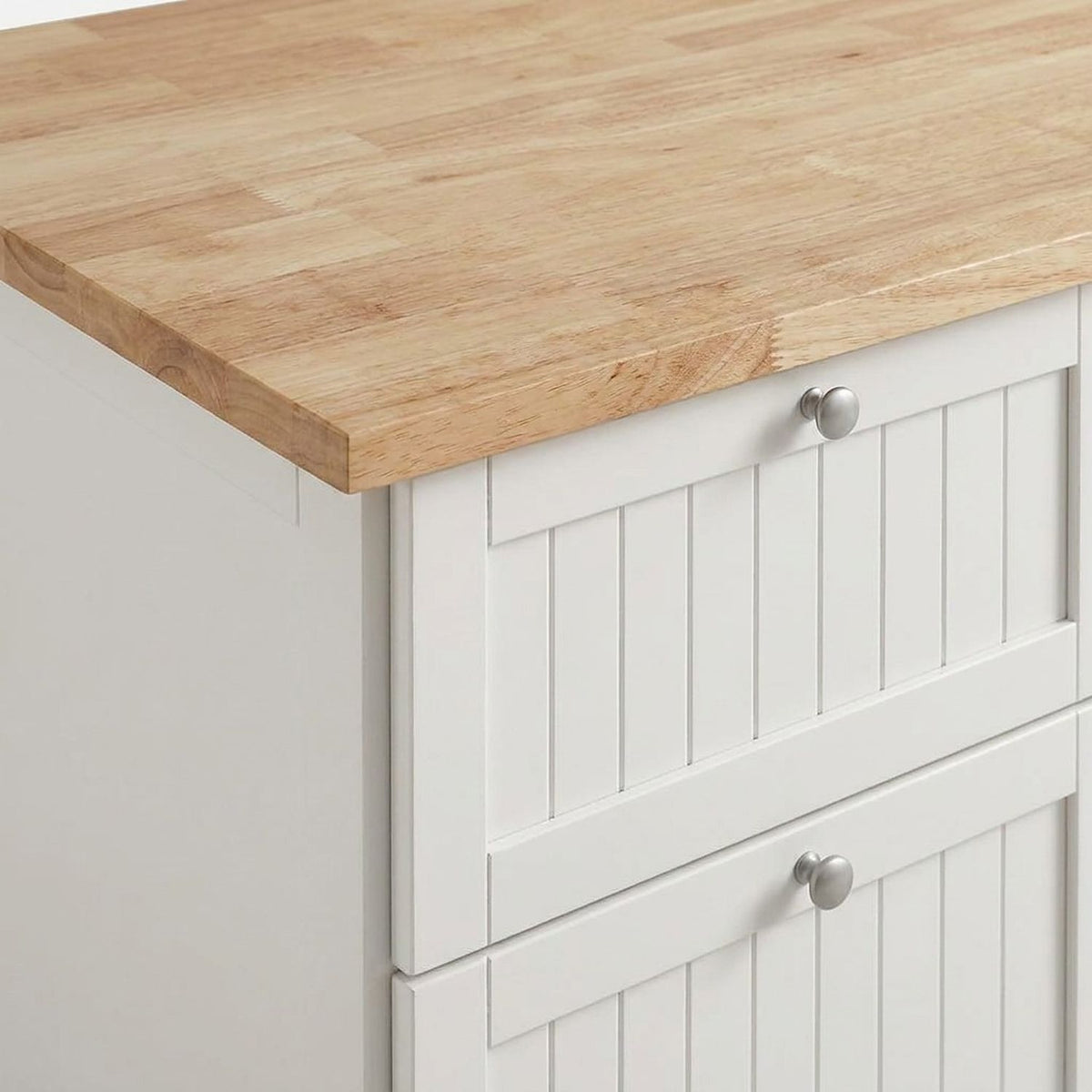 Rubberwood butcher-block top over white beadboard drawer fronts with round silver knobs (close-up detail)