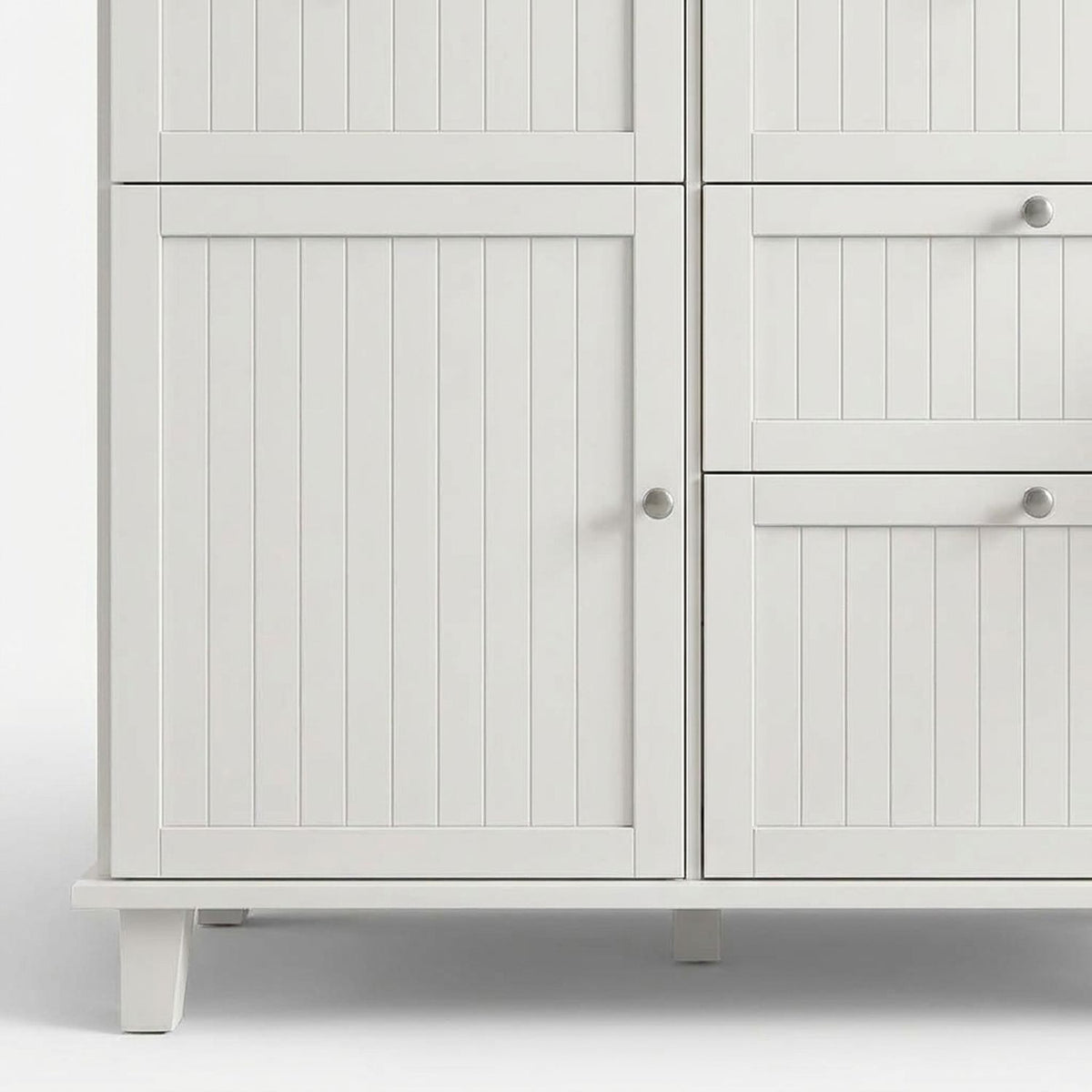 Beadboard cabinet door, stacked drawers and white tapered feet, front (close-up detail)