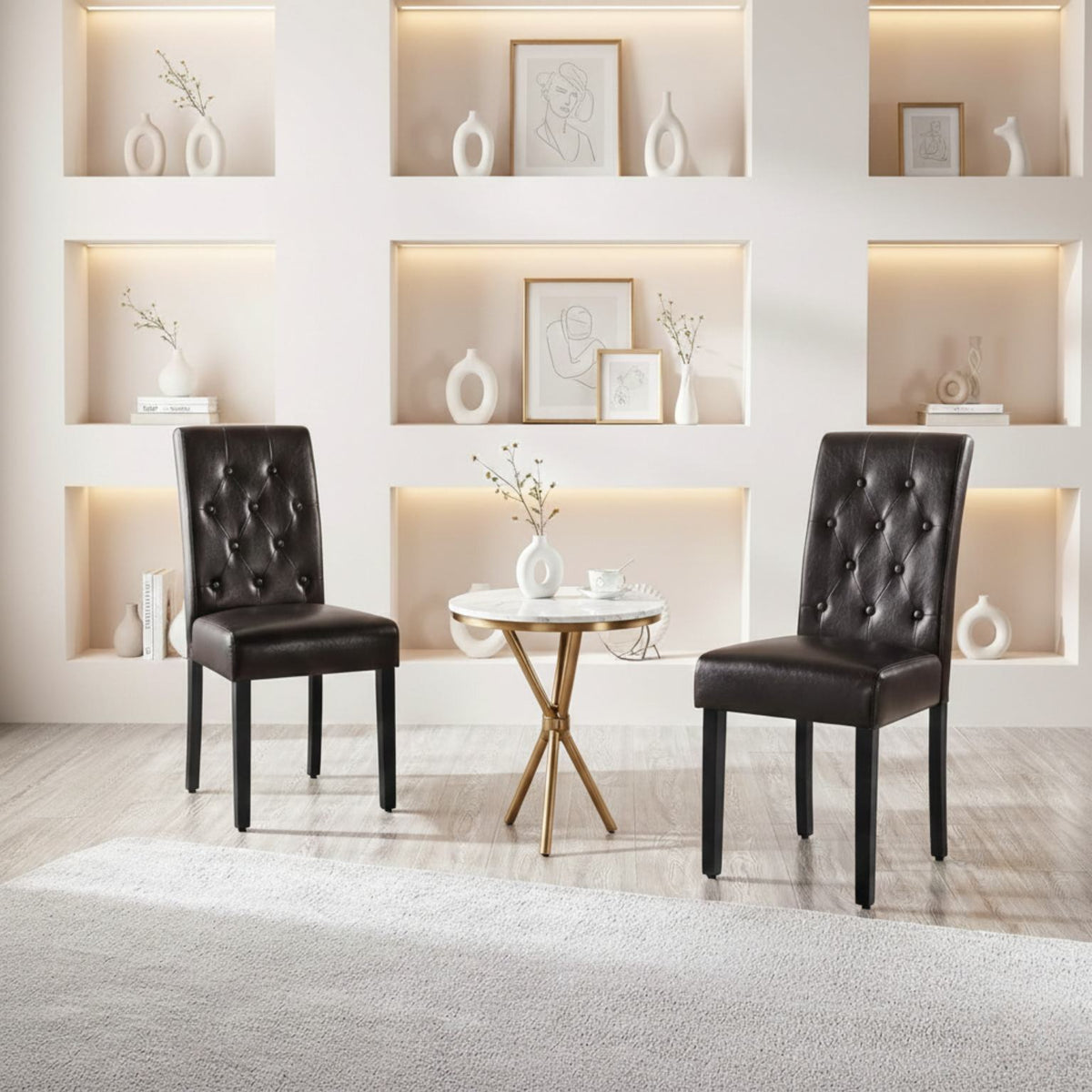 Pair of black dining chairs with wooden legs beside a round side table