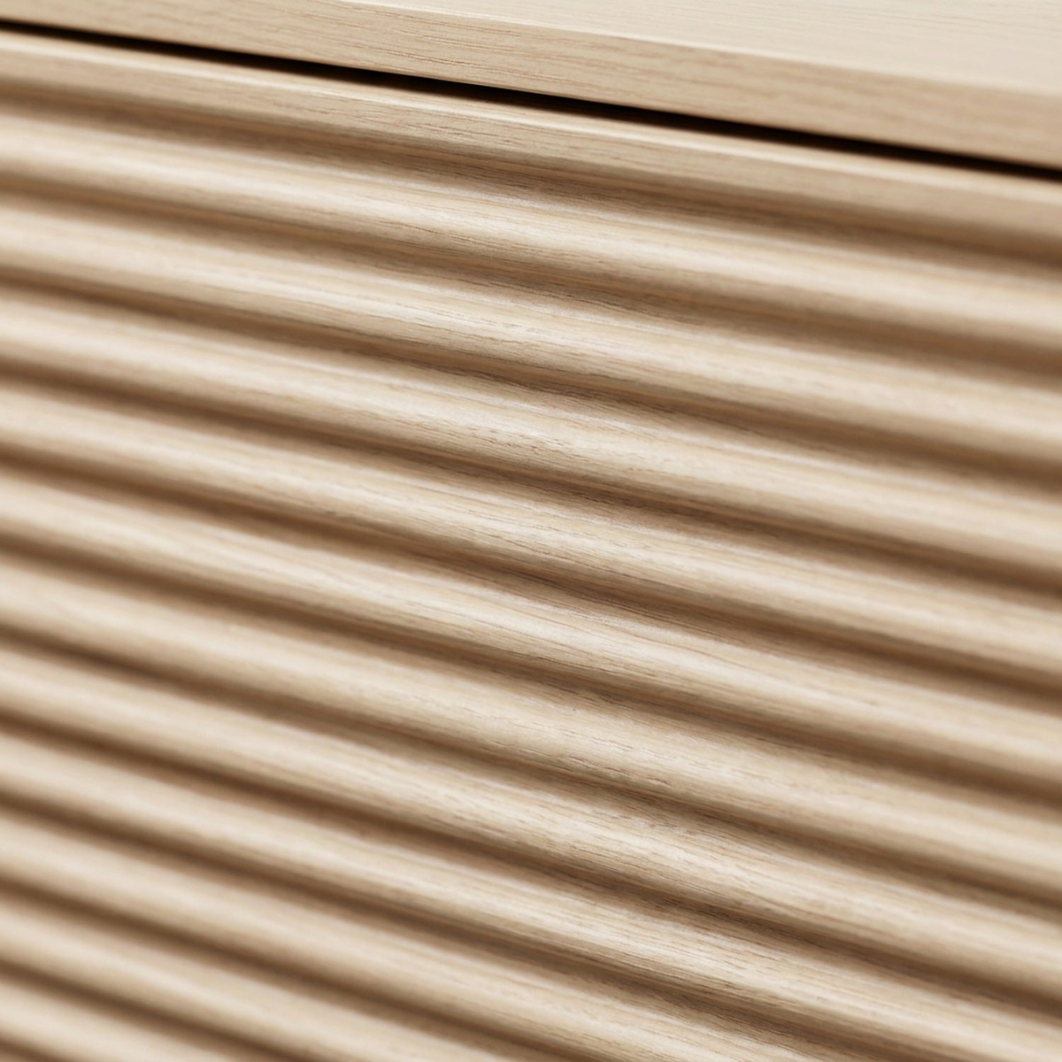Rounded oak reeds and the top track of the sliding door, filling the frame (close-up detail)