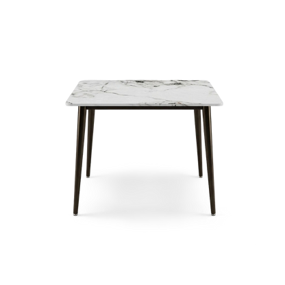 Square sintered stone dining table with dark bronze metal legs, front view on transparent background