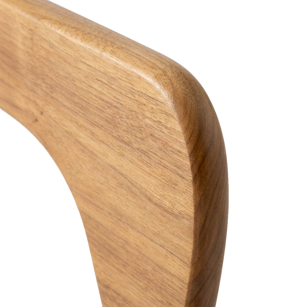 Close-up of the walnut wood grain and sculptural curved edge on the coffee table base