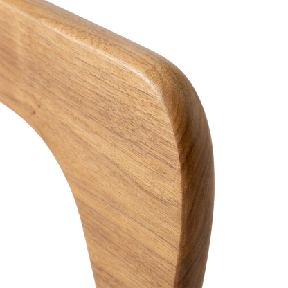 Close-up of the walnut wood grain and sculptural curved edge on the coffee table base